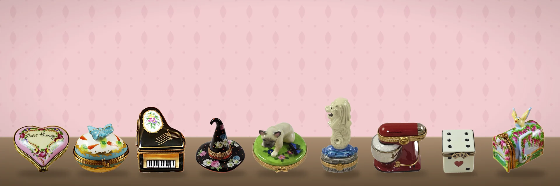 Hand-painted French Limoges boxes arranged on a painted backdrop
