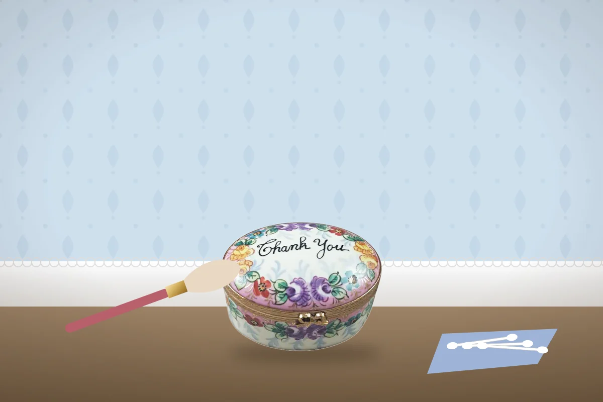 A floral Thank You Limoges box with a soft brush, cotton swabs and a microfiber cloth.