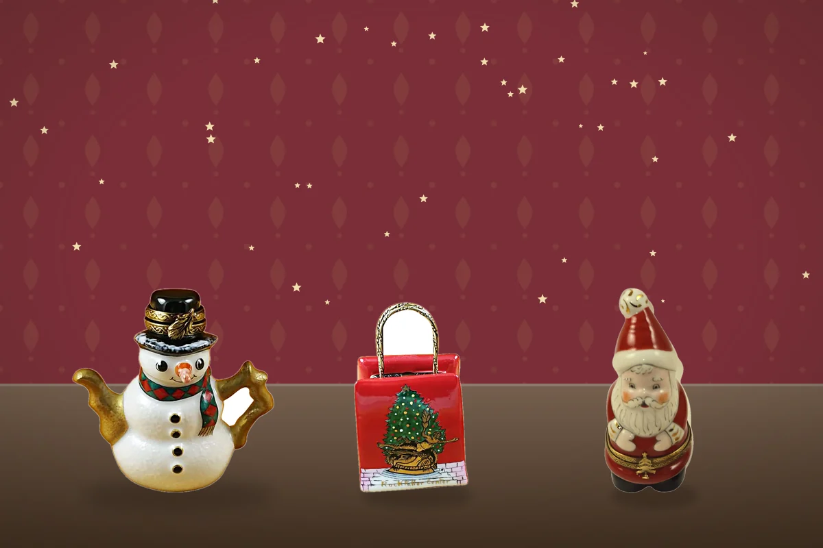Three Christmas Limoges boxes: a snowman teapot, a red gift bag with a tree, and a Santa.