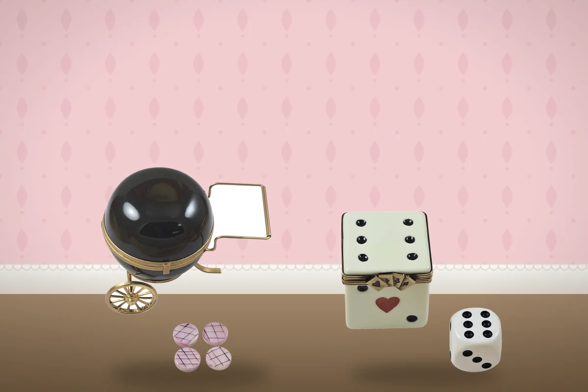 A barbecue grill box with tiny removable porcelain burgers and a dice box with a loose porcelain die.
